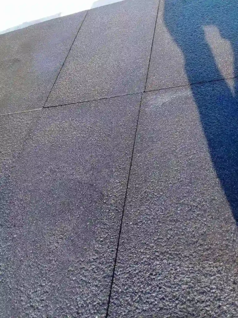 Several dark basalt pavers with a rugged, bush-hammered finish laid closely together, showing consistent charcoal tones.