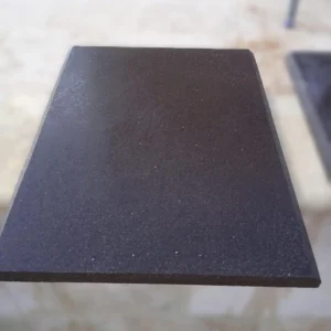 Rectangular black basalt paving slab with elegant beveled edges and a textured matte finish.