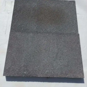 Side view of black basalt pavers showing uniform calibrated thickness for easy professional installation.