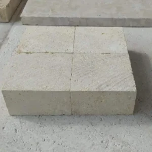 Warm golden-yellow natural stone setts with sawn edges for an inviting garden walkway.