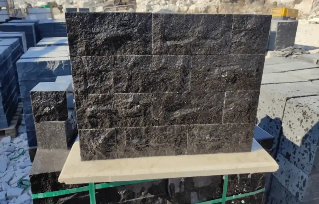 Deep charcoal basalt paving blocks installed in a residential driveway for maximum load-bearing durability.