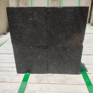 Precision-cut black basalt cobbles with a smooth sawn top finish for a level paving surface.