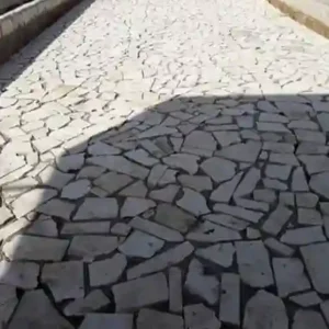 Irregular white limestone crazy pavers in a natural mosaic pattern for a luxury Mediterranean-style patio.