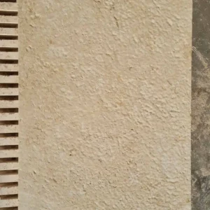 Weathered antique finish stone patio tiles with soft edges for a traditional garden terrace.