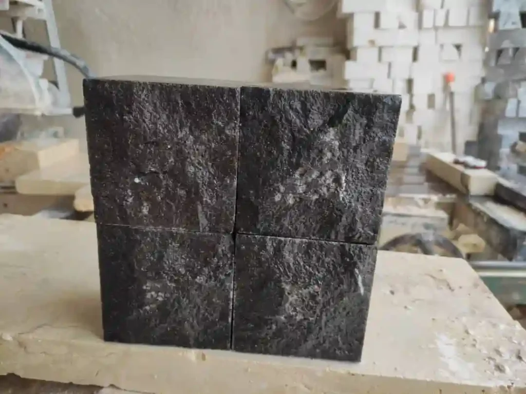 black basalt cobbles showing deep jet-black color and natural split-face texture.