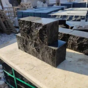 Traditional European fan pattern installation using black basalt cobble setts for a luxury driveway.