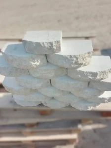 Chiseled surface white limestone walling stone with rounded edges for garden retaining walls.
