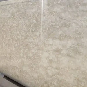 Polished Ocean Reef Shellstone floor tiles on a luxury covered patio, showing a smooth reflective surface.