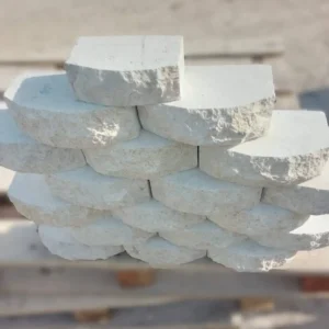 White limestone walling blocks with a natural split-face and rounded surface for a textured 3D wall.