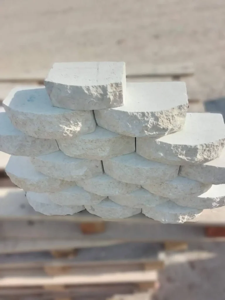 White limestone walling blocks with a natural split-face and rounded surface for a textured 3D wall.