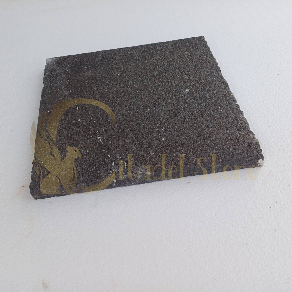 A beautiful display of black basalt tiles showcasing their natural stone texture.