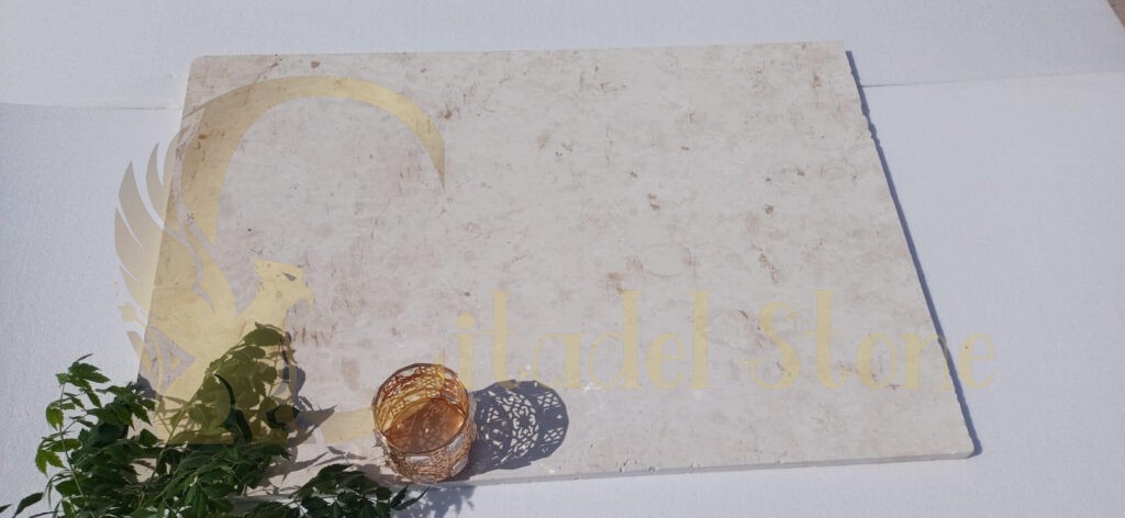 A close-up view of white limestone tiles showcasing their unique features.