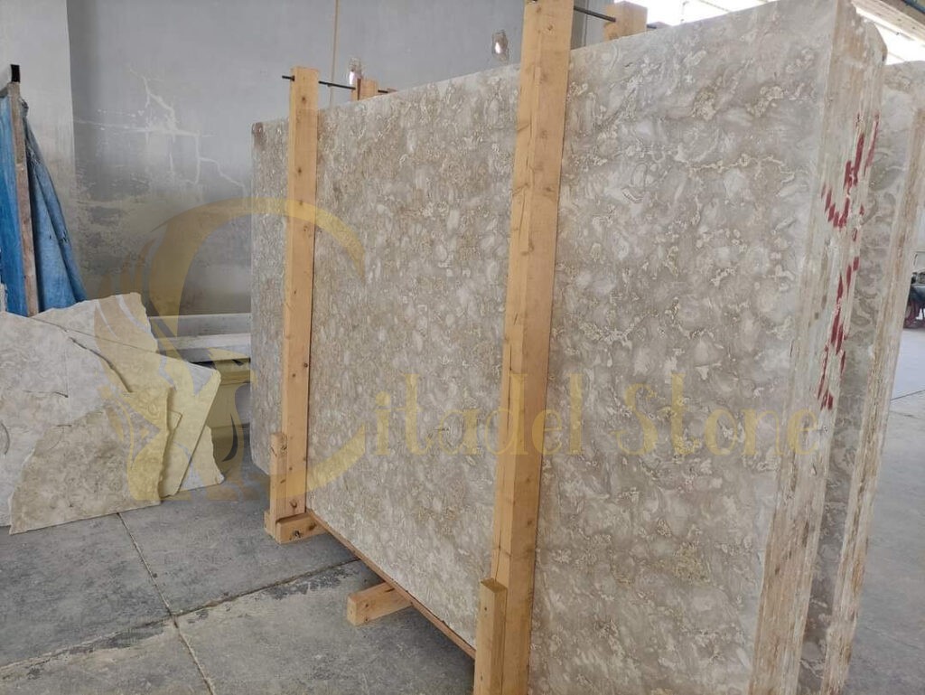 An outdoor patio featuring shellstone pavers surrounded by greenery, enhancing the coastal aesthetic.