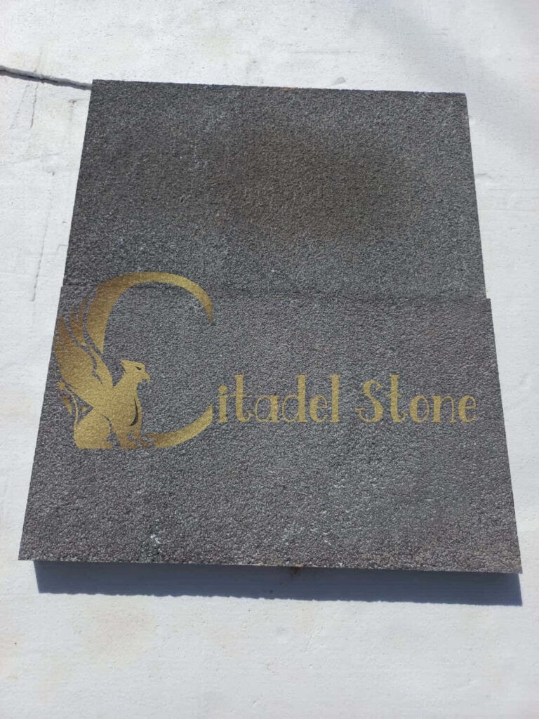 Cleaning black basalt tiles with appropriate tools and solutions.