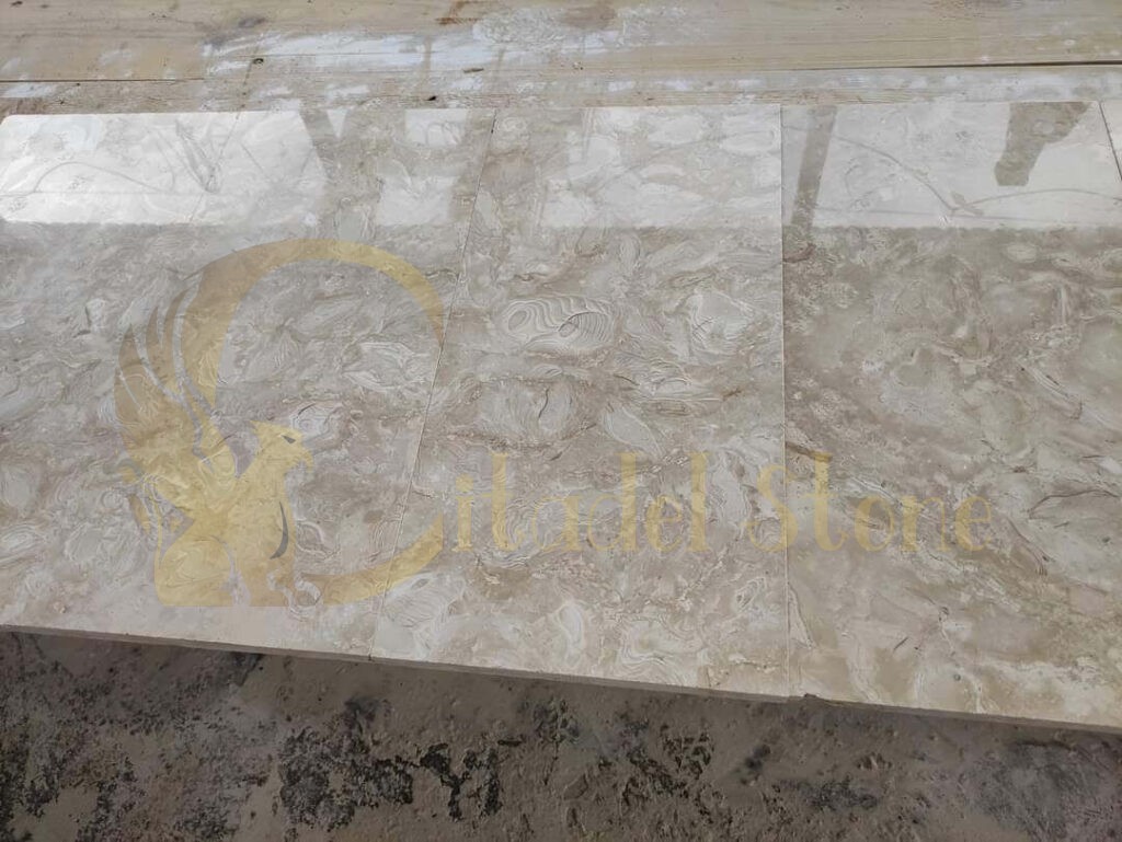 Different finishes of shellstone pavers displayed in an outdoor setting.