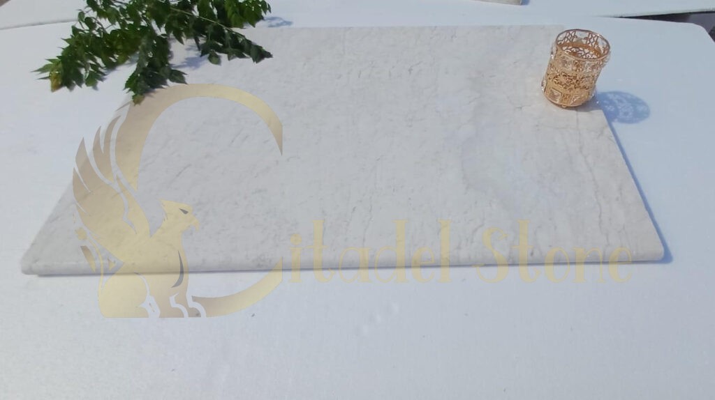 Happy customers showcasing their white limestone tile installations.