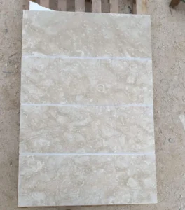 A photo of beige Shellstone pavers with a honed finish, showcasing their smooth texture.