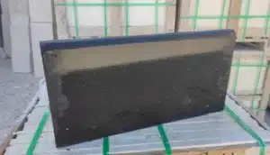 Basalt pavers enduring heavy weight in a strength test.