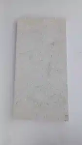 Person mopping white limestone tiles