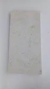 Person sealing limestone tiles