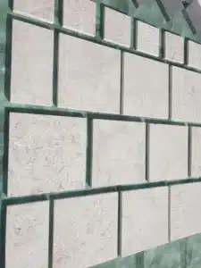 White limestone coping on rustic pool