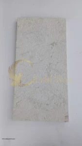 Person sealing limestone pavers