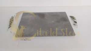 Angle grinder shaping basalt