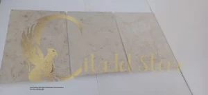 Bright hallway with highly polished light-colored limestone floor tiles reflecting light