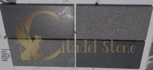 A mosaic of basalt, bluestone, granite, and travertine samples