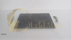 Sleek basalt paver patio in a modern architectural setting