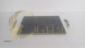 A modern kitchen with honed basalt countertops and flooring | This image showcases a high-end interior application of the finish.