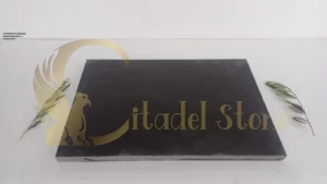 A professional applying a penetrating sealer to honed basalt