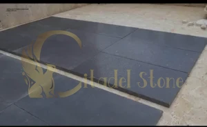A professional cleaning a honed basalt surface with ease