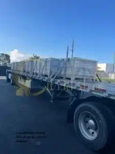 A truck being loaded with stone at a port for delivery
