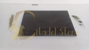 A honed basalt pool deck with water on its surface