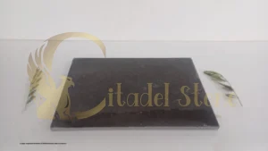 A large, organized inventory of finished basalt slabs in a factory