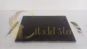 A CNC machine precisely cutting a block of basalt