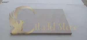 A person using a soft broom to sweep a limestone floor