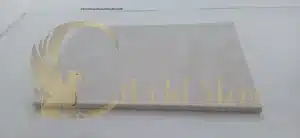 A clean limestone entryway during a light snowfall