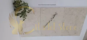 Close-up of a white limestone paver installed with wide, permeable joints