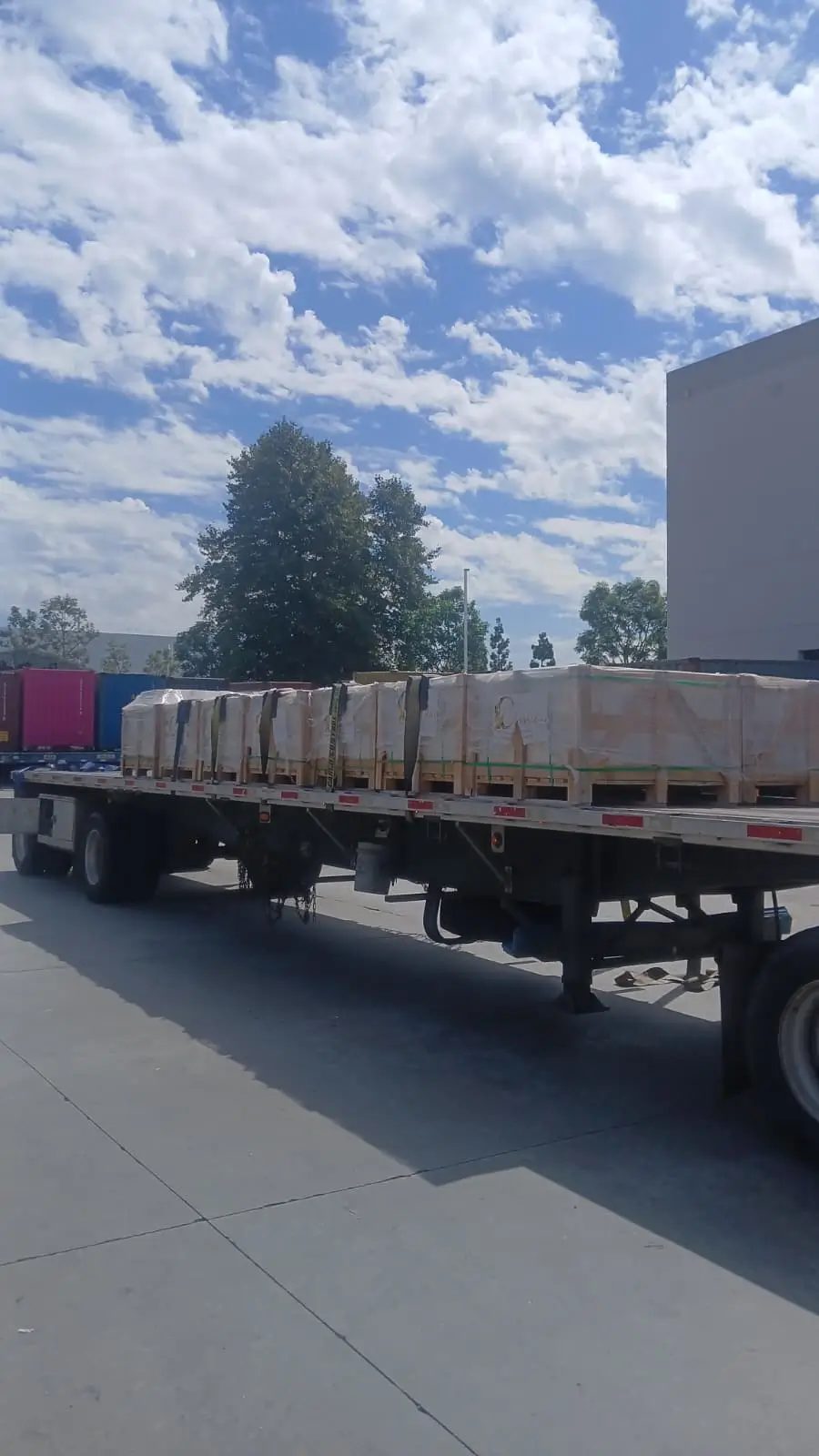 Delivery truck loaded with secured crates of granite cobblestone paver cost Arizona materials ready for transport.