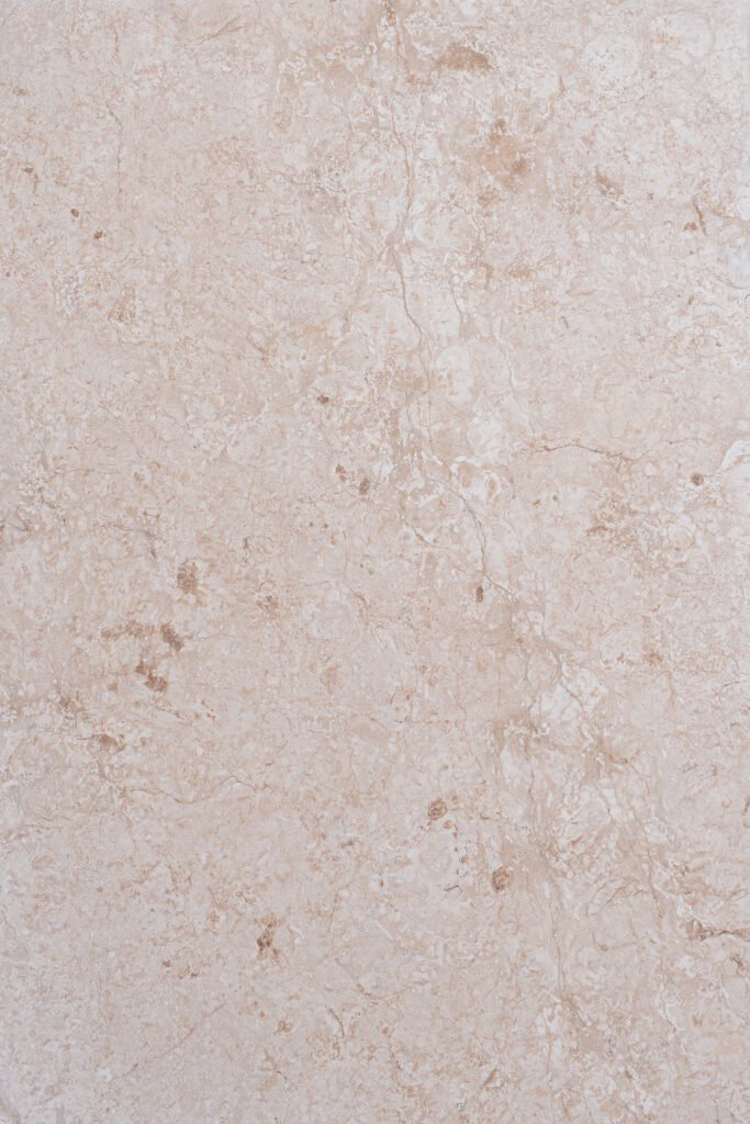 Close-up polished royal cream limestone surface amber iron oxide inclusions