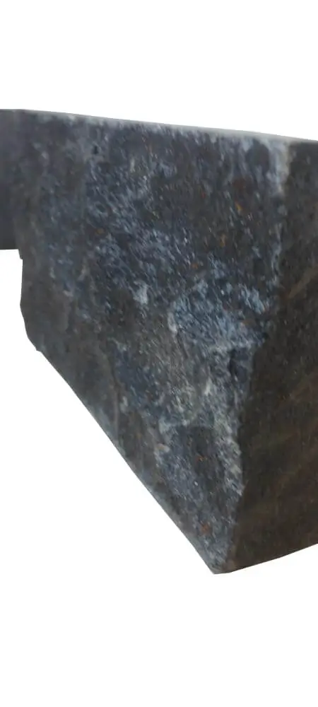 Close-up view of the textured surface of dark natural stone.