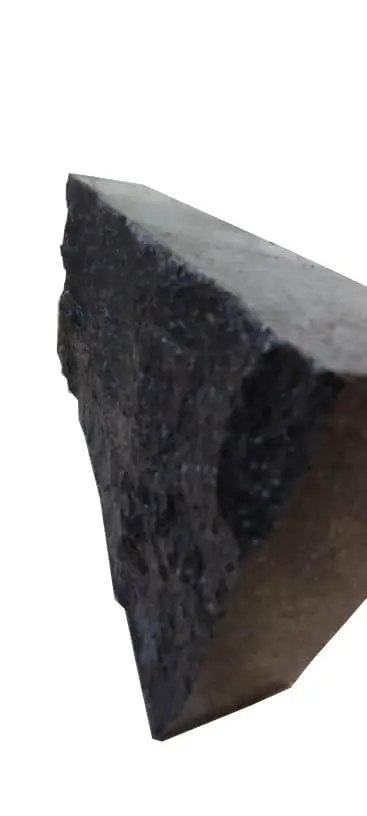 Close-up view of the textured dark stone surface and edge.