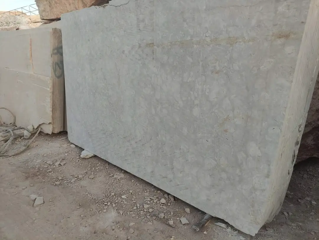 Close-up view of a large, light gray stone slab with subtle texture.