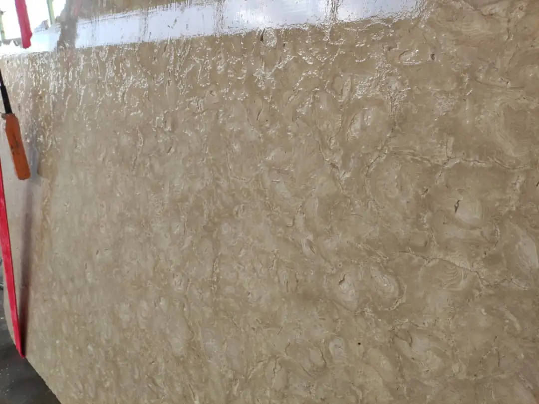 Close-up of a polished beige travertine stone slab with natural swirling patterns.