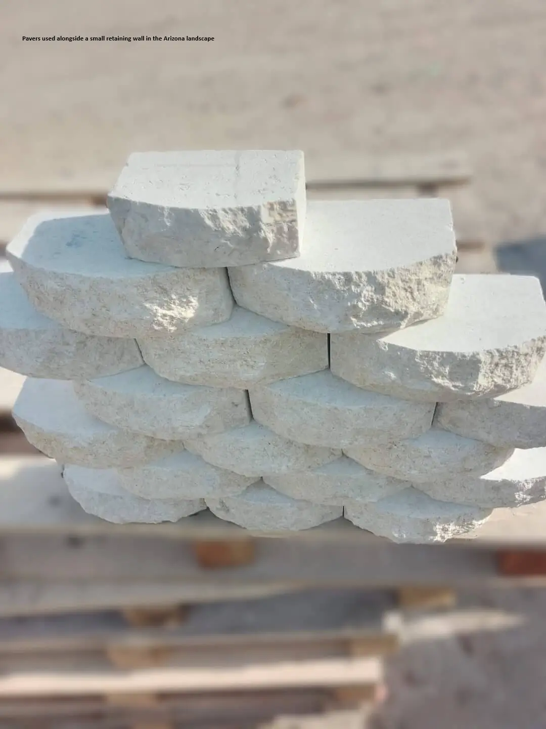 White Stone Pavers Stacked Close-up Neatly stacked white stone pavers with rough textured edges and rounded faces.