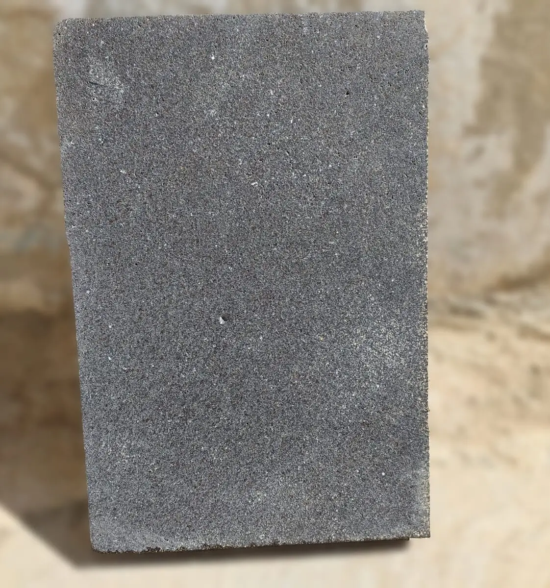 Close-up texture of dark gray stone pavers showing granular surface details, shown for natural stone window sill cost.