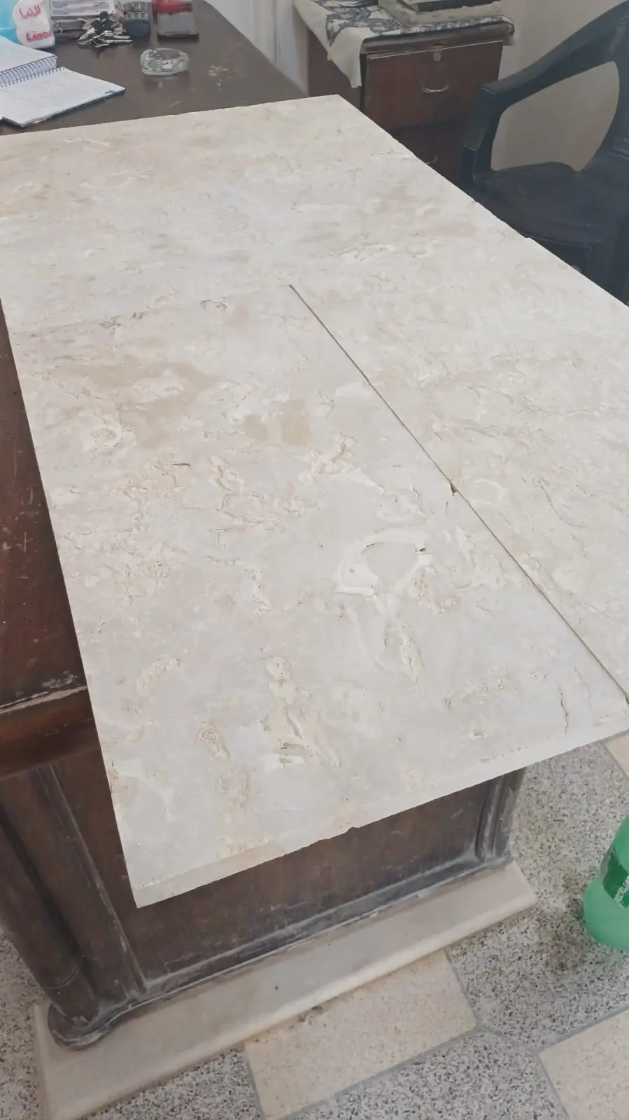Light-colored marble slabs with natural veining and textures laid on a surface, a reference for limestone for patio.