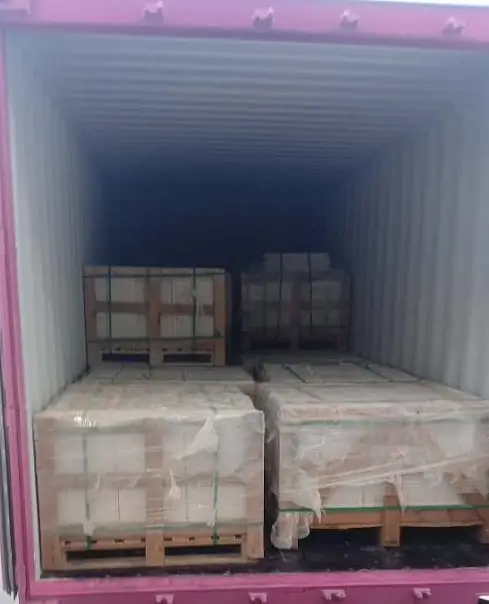 Delivery truck transporting stacked natural stone crates for large landscaping rocks installation.